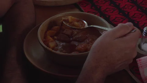 Older man eats traditional hungarian bogracs soup in Heviz, Hungary - Editorial Stock Footage 229970796