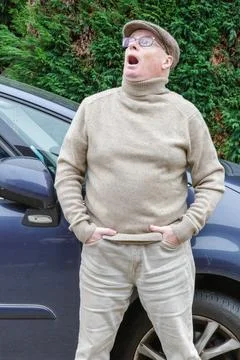 Older man with an expression of astonishment or surprise on face looks upwards Stock Photos