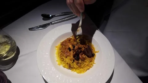 Older man in first class eating a gourmet meal on a flight in the dark Stock Footage 279156314