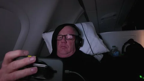 Older man in First Class on a flight watching his smartphone Stock Footage 315654830