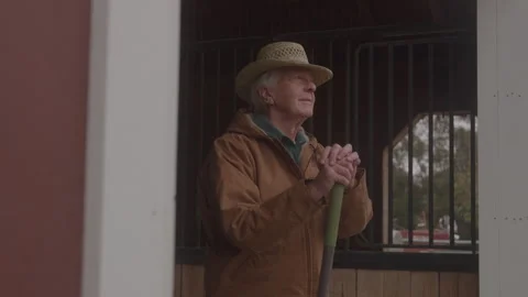 Older Man In Hat Looking Out From Barn Holding Pitchfork Stock Footage 270334771