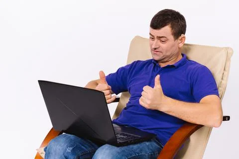 An older man with hearing problems communicates via online video using gestures Stock-Fotos