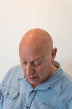 Older man looking down, bald, alopecia, chemotherapy, cancer, isolated Stock Photos