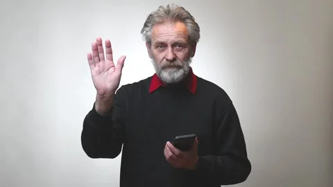 Older man in senior age operating with smartphone isolated on background 스톡 동영상 321196082