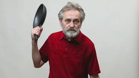 Older man in senior age operating with handgun pistol isolated on background Stock Footage 321196102