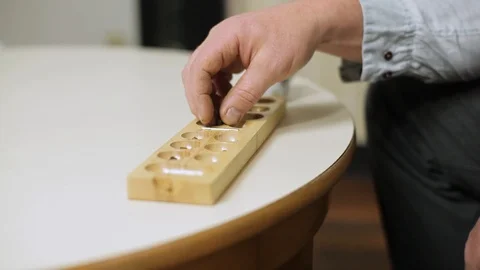 Older Man Sorting Out Beads Out Of A Wooden Divider Stock Footage 126700671