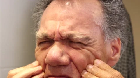 Older man squinting with both eyes Stock Footage 230911091