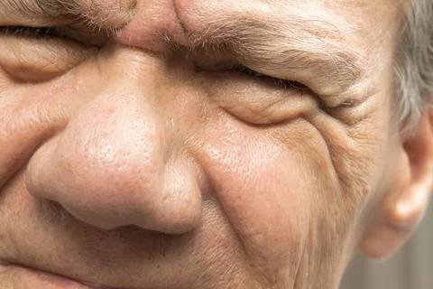 Older man squinting with both eyes Stock Photos