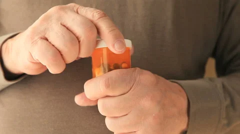 Older man struggles with pill container Stock Footage 62866173