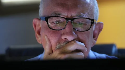 Older man talking back and upset at his computer Stock Footage 54567660