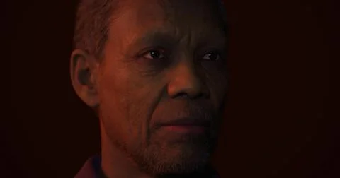 Older man with thoughtful expression in dark setting featuring warm lighting Stock Illustration