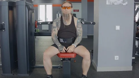 An older man is training on multi press machine. Stock Footage 115429972