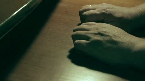 An older man tries to restore feeling to his numb hand Stock Footage 69158451