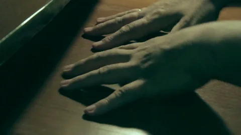 An older man tries to restore feeling to his numb hand Stock Footage 69158698