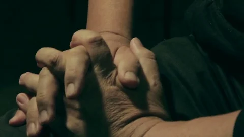 An older man tries to restore feeling to his numb hand Stock Footage 69161241