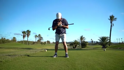 Older man warming up for golf. Movements with a golf club in hand on the gr.. Stock Footage 252603881