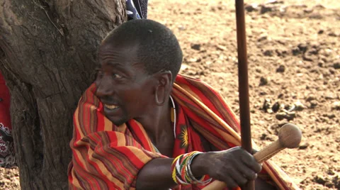 Older masai man sitting under tree Stock Footage 33688568