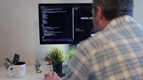 Older Office Worker AI Vibe Coding in Home Office Stock Footage 325326437