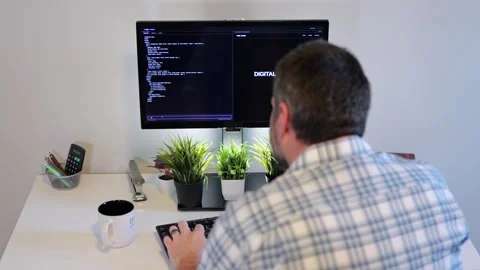 Older Office Worker AI Vibe Coding in Home Office Stock Footage 325326810