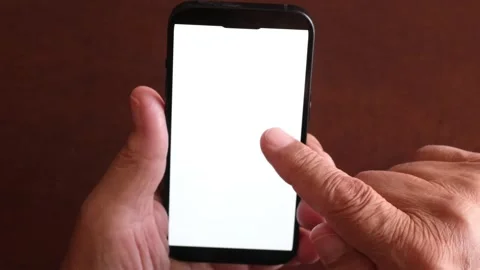 Older person's hands holding a black smartphone with a white screen, scrolling Stock Footage 344389772