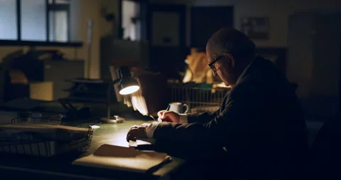 Older professional man writing documents at desk in interior lawyer office with Stock Footage 199460051