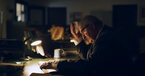 Older professional man writing documents at desk in interior lawyer office with Stock Footage 199460893