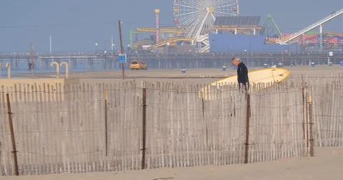 Older surfer walking with board on santa monica beach Stock Footage 87394393