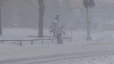 Older walking in snowstorm with cane Stock Footage 103869379