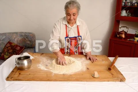 Older Woman Baking In Living Room