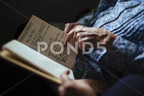 Older Woman Reading Handwriting To Granddaughter