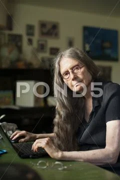 Older Woman Using Laptop At Desk
