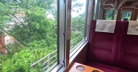 The oldest train in Japan is going up the mountains, Hakone town window view Stock Footage 259309203