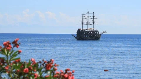 Oleander flowers and a pirate ship sailing on the Mediterranean Sea Stock Footage 103515744