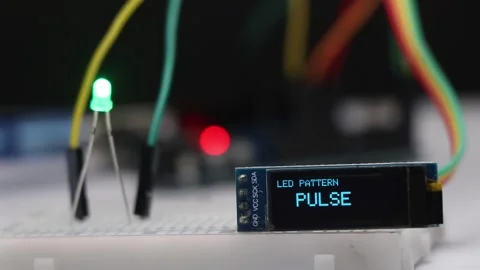 OLED screen displaying different LED lighting patterns while a green LED Stock Footage 336626472