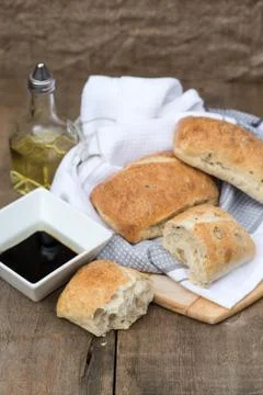 Olive bread rollis in rustic kitchen setting with utensils Stock Photos