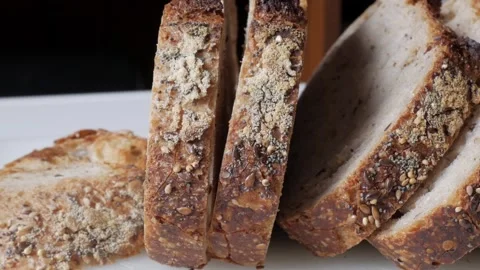 Olive bread slice showing mold and seeds with a rustic and organic appearance Video stock 312845449