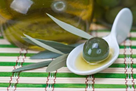 Olive in a china spoon Stock Photos