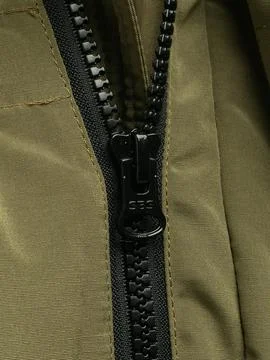 Olive jacket zipper pull close up angle Stock Photos