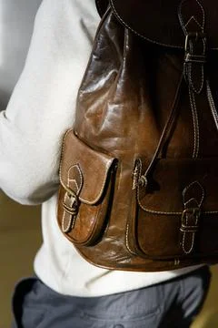 Olive leather oldfashioned backpack on a mans back Stock Photos