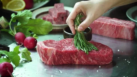 Olive oil is being applied to raw meat. 動画素材 334358069