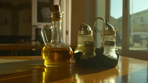 Olive oil bottle and condiments on wooden restaurant table Stock Footage 330535650