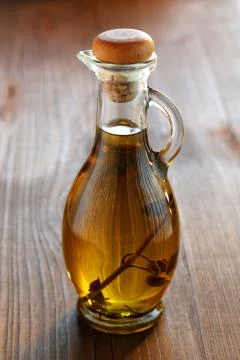 Olive oil bottle on a rustic table Stock Photos