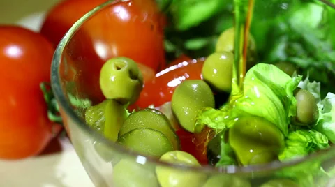 Olive oil flows in salad. Close up Stock Footage 35994509