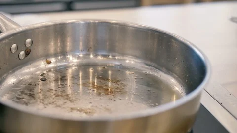 Olive oil is poured into the pan with a thin stream Stock Footage 125922148