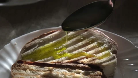 Olive oil pouring to bread Stock Footage 154814998