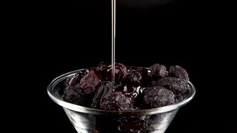 Olive Oil Pouring Over Rustic Black Italian Dried Olives – 360° Rotation Stock Footage 312148032
