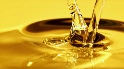 Olive oil pours in a stream with splashes. Filmed on a high-speed camera at 1000 Stock Footage 202142693