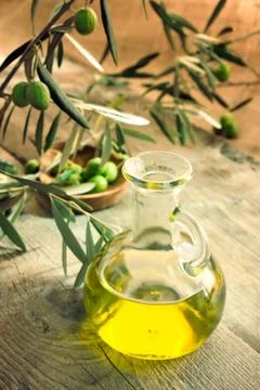 Olive oil on rustic background Stock Photos