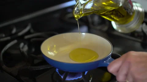 Olive oil on small pan  Slowmo Stock Footage 201646851