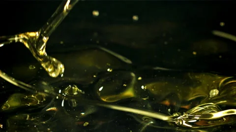 Olive oil with splashes on black background. Filmed on a high-speed camera at Stock Footage 263278293